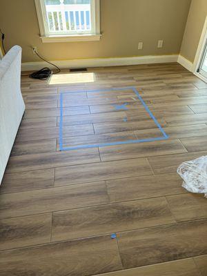 Pictures of the tile floor showing defects of installation