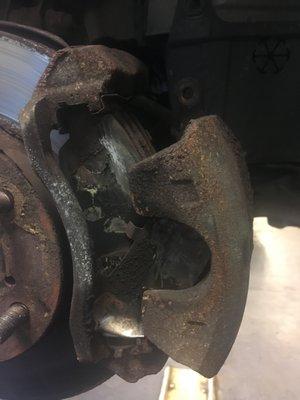Brake and caliper on passenger side. Notice missing bolts