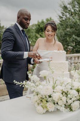 Elegant floral styling by Scarlett Blooms for this editorial wedding shoot--featuring soft white blooms and a classic cake moment.