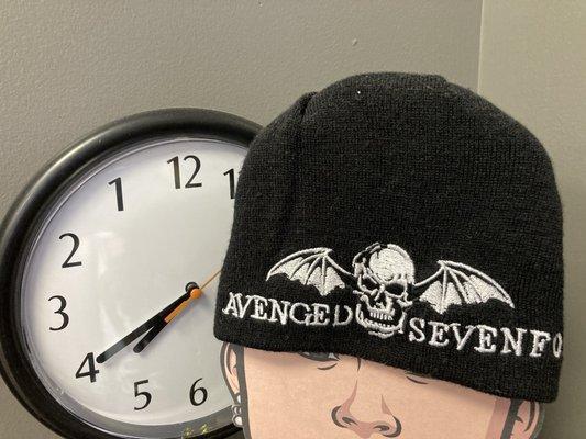 in the seating/waiting area: a wall clock that runs backwards, a cap from Avenged Sevenfold, etc.