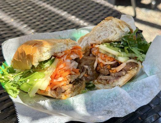BBQ Pork Banh Mi at a table on the pleasant patio