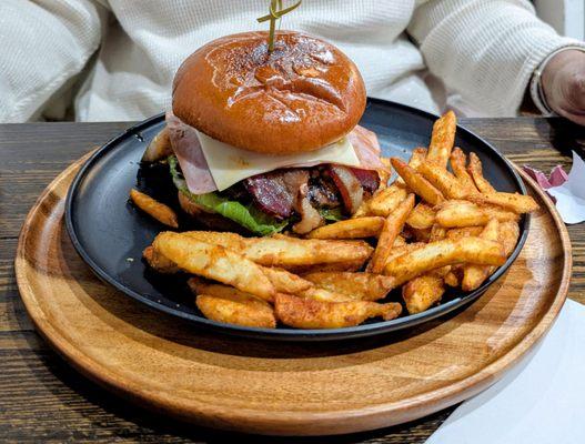 Burger, ham, sausage, and bacon with fries