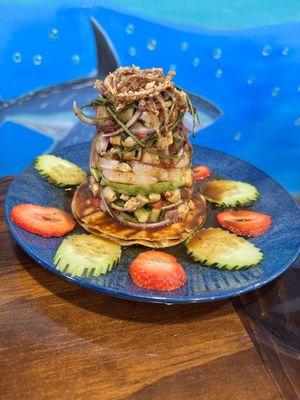 Tostada La FRESITA. (Strawberry, tuna, mahi-mahi, raw shrimp, cooked shrimp, octopus, cucumber & onions). With special sauce.