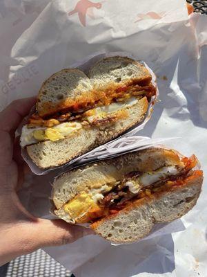 Bacon egg and cheese on a sesame bagel. With Gertie hot sauce and pickled peppers!