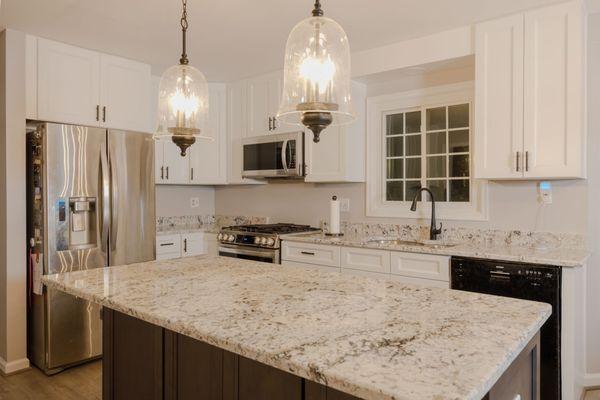 Stylish kitchen renovation by one of the top-rated kitchen remodeling companies in Maryland with granite countertops, and shaker cabinets.