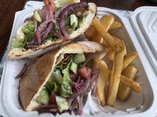 Chicken shawarma sandwich, my bad for the pic, I got too excited. The salad on top is hiding the chicken, hummus, and garlic sauce.