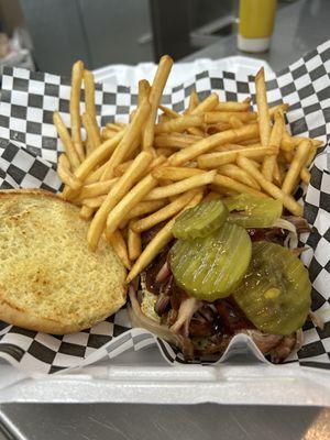 Pulled pork sandwich with fries. Topped with pickles or coleslaw.