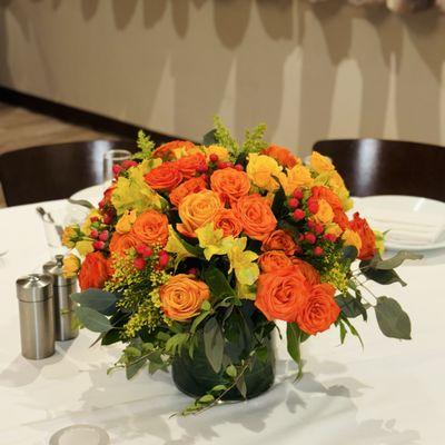 Beautiful centerpiece for any occasion, orange and yellow flowers gracefully arranged beautifully.