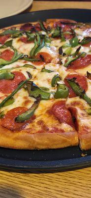 Gluten free pepperoni and green peppers pizza.