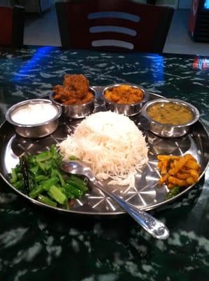 Chicken thali: bird, potatoes, dal, achar, greens, yogurt, and rice