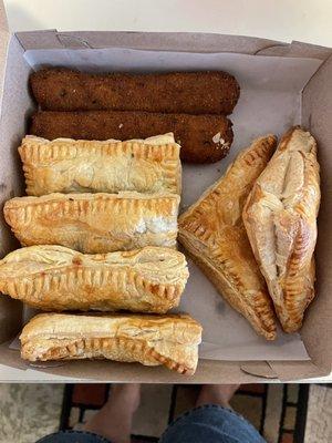 My take out box top is fish rolls. Bottom left is bacon and egg pastries and to the extreme right is egg and seeni sambol pastries.