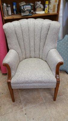 Gray and white upholstered channel-back chair.
