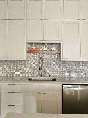 Kitchen cabinet edge pull hardware and floating shelf.