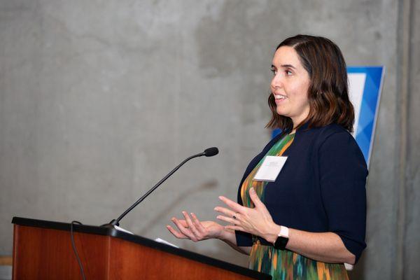 Liz Calora, former president of Washington Women Lawyers, speaking at a WWL event in 2021--an organization we proudly support.