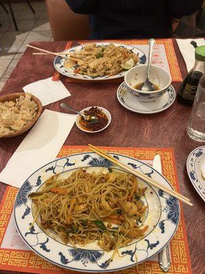 Pad Thai and Singapore noodles. A cup of almost finished hot and sour soup.