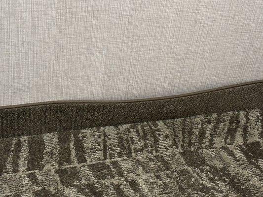 Carpet pulling away from the wall from being soaked.