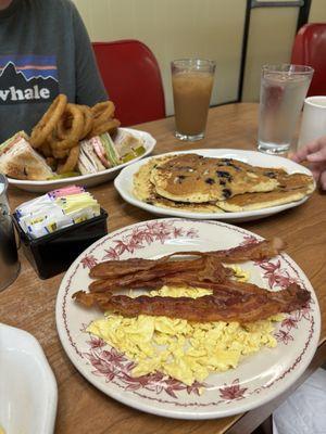 Turkey club, blueberry pancakes, and side of bacon and scrambled eggs