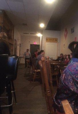 Some seating along the wall (bar on left)