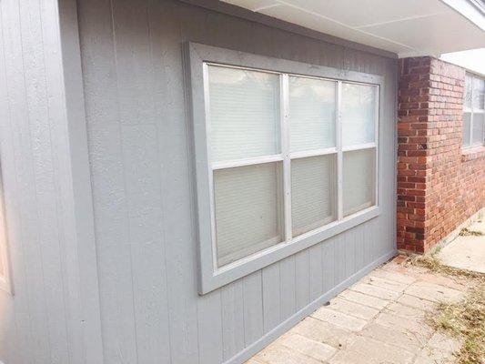 New siding primed and painted after tear off of old rotted siding