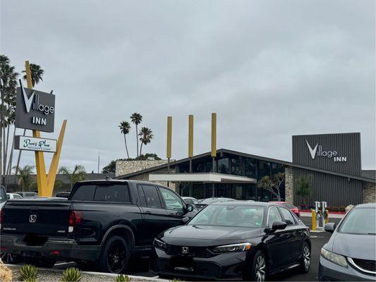 Picture taken from the road in front of the motel. Note the chargers for electric vehicles.