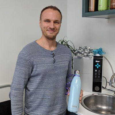 Friend filling up a water bottle with Ion Thrive Hydrogen Rich Water at IMPaX Health in Folsom, CA