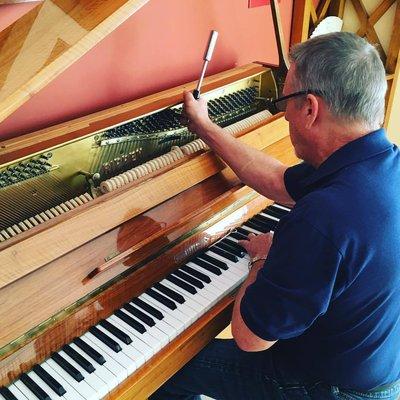Tuning an upright piano.