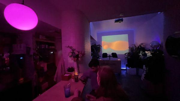 Where the DJ plays with a complementary light show projected on the wall.