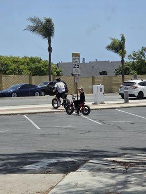 Boys doing tricks wheelies on ebikes on Bolsa Ave from CVS to McGaugh Elementary
