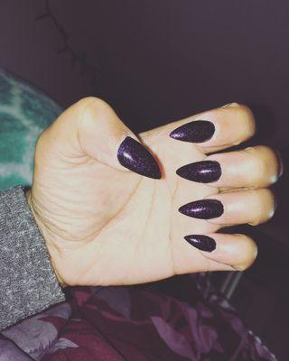 Acrylic Set (Claw Shape) First coat of polish is black. Second color is clear with purple glitter