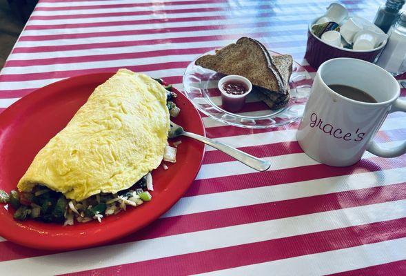 Fabulous Veggie Omelette, toast with homemade strawberry jam and coffee on a cheerful tablecloth
