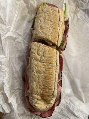 Italian sub with everything on white roll.