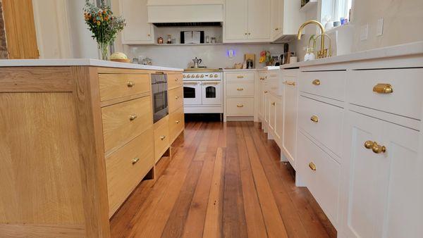 White oak island and painted traditional inset shaker kitchen cabinets.