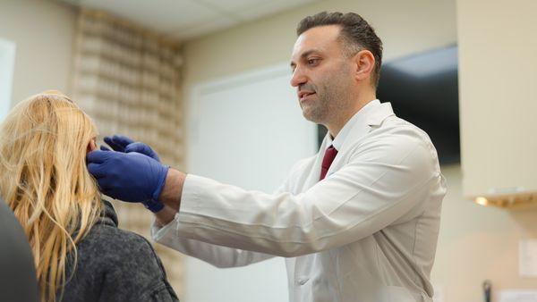 Dr. Adar doing a yearly skin check