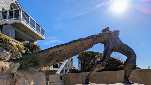 Looks like Guts from the late Kentaro Miura's manga "Berserk", swinging a massive sword to slice the sun in half.
