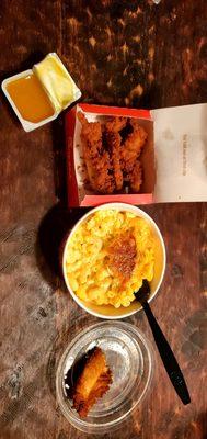 The chicken strips, large side of mac and cheese, and honey mustard sauce.
