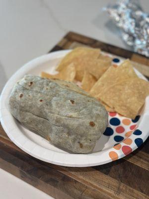Steak burrito with some of the chips they gave us in a to-go bag