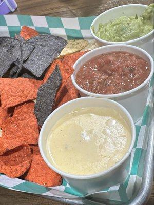 Chips with queso, salsa, and quac.