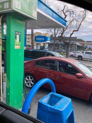 A car parked in front of the pump for Burger King. No way to use this station because nobody does anything about it. Ever