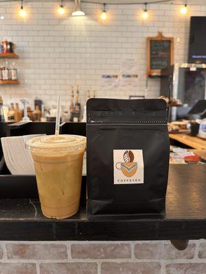 Pistachio latter with oat milk and bag of Coffeyeh coffee beans.