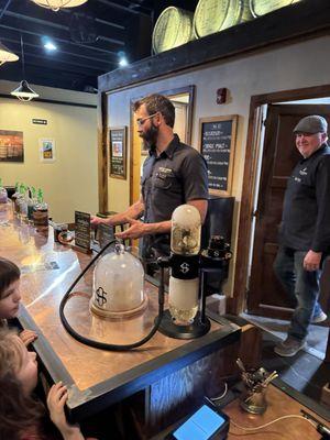 Clayton making a smoked cocktail.