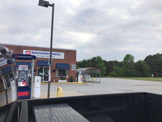 Propane fill and red farm diesel pump