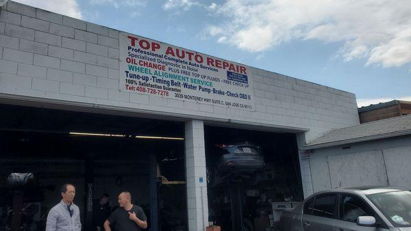 Toc (right, black shirt) speaking with another customer