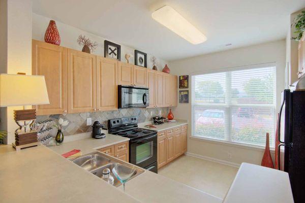 Kitchen with black appliances and breakfast bar seating