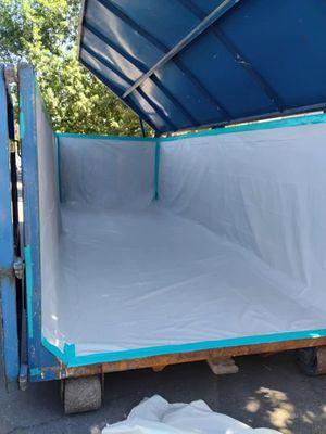 Neatly Lined dumpster ready for removal of asbestos containing material