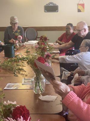 Residents at Embassy at Hearthside making flower vases in gardening club!