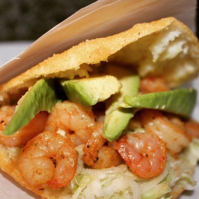 Shrimp Arepa: a mouth watering crispy arepa filled with plenty of flavor on house recipe cole slaw, avocado and home made sauces.