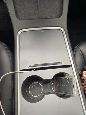 Filthy cup holders and some sort of coffee/ drink residue all over the console door.