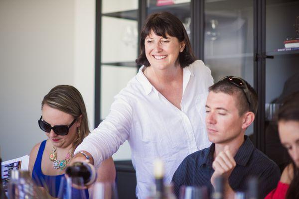 Diane Bucher sharing Bucher Wines with guests.