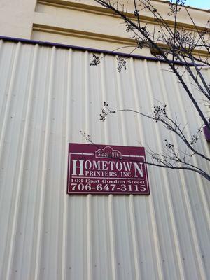 Exterior signage at HOMETOWN PRINTERS in Thomaston, Georgia.