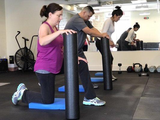 Clients are performing assisted lunges during our foundations class.